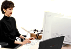 This image is a Woman sitting in front of the computer